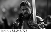 Medieval knight holding sword in black and white portrait. Стоковое фото, фотограф David Kashakhi / Фотобанк Лори