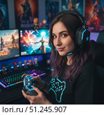 Fashionable Profession gamer - portrait of a young woman at a computer desk. AI generated. Стоковое AI-изображение, AI-художник Андрей Аркуша / Фотобанк Лори