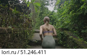 Slow motion follow-up Shot of Young Athlete Woman Running. Outdoor training in Bali. Стоковое видео, видеограф Степанов Григорий / Фотобанк Лори