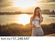 Young beautiful caucasian girl listening to music with smartphone walking in the city with headphones smiling - relax, youth, emancipation concept. Стоковое фото, фотограф Арзюков Вадим Николаевич / Фотобанк Лори