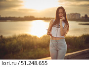 Young beautiful caucasian girl listening to music with smartphone walking in the city with headphones smiling - relax, youth, emancipation concept. Стоковое фото, фотограф Арзюков Вадим Николаевич / Фотобанк Лори