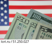 US Currency on American Flag Background Display. Редакционное фото, фотограф Sergakoff / Фотобанк Лори
