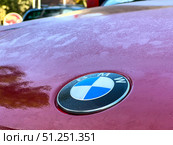 A red car with a Bmw emblem on the hood. Russia. Moscow. 05.09.25. Редакционное фото, фотограф Ярославский Максим / Фотобанк Лори