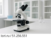 A Modern Laboratory Microscope Set Against a Bright, Well-Equipped Science Workspace, Ready for Precision Observations and Experiments. Стоковое AI-изображение, AI-художник Башкирова Анна / Фотобанк Лори