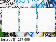 colorful urban wall texture with three wrinkled glued poster templates. Стоковое фото, фотограф Александра Конопля / Фотобанк Лори