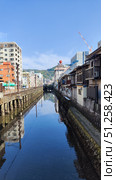 Nagasaki, Japan - May 12, 2025. Canal in middle of the city. Стоковое фото, фотограф Константин Никитеев / Фотобанк Лори