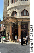 Galata Tower in Istanbul, view from the narrow street Narrow street with Galata Tower and historic building in Beyoglu district, Istanbul, Turkey Beautiful view of city street with different stores. Редакционное фото, фотограф Zita Khasanova / Фотобанк Лори
