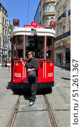 Istanbul red retro tram isolated on white background. Travels between Taksim and Tunnel. Translation: Tunnel Winter and Red Tram in Istiklal Street, Beyoglu, Istanbul. The second underground metro in the world, Istanbul Taksim Tunnel. Turkey Istiklal Avenue, Tunel, Beyoglu, Istanbul. Редакционное фото, фотограф Zita Khasanova / Фотобанк Лори