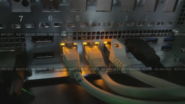 A close-up video of blinking LED lights at RJ-45 connector ports on active network servers, creating a futuristic symphony of rhythmic pulses. Стоковое видео, видеограф Виктор Ветошкин / Фотобанк Лори