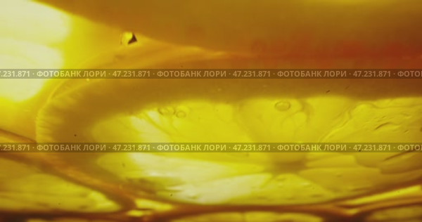 A CloseUp Image of a lemons Shimmering Golden Liquid that has Bubbles Floating in It, Captured Beautifully. Стоковое видео, видеограф Владимир Ковальчук / Фотобанк Лори