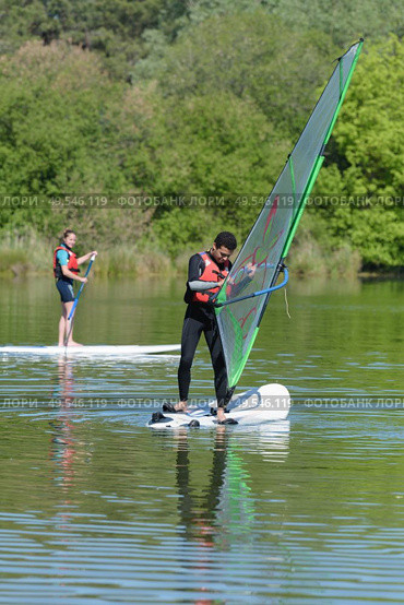 a couple of windsurfer on the lake. Стоковое фото, агентство Ingram Publishing / Фотобанк Лори