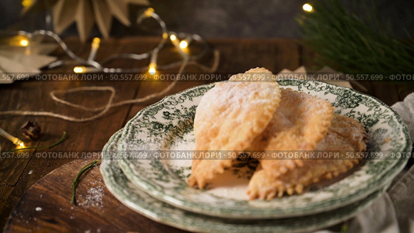 A crescent-shaped pastry whose filling is made of eggs and almonds wrapped in crispy dough, cut in an artisanal way and sprinkled with sugar. Стоковое фото, агентство Ingram Publishing / Фотобанк Лори