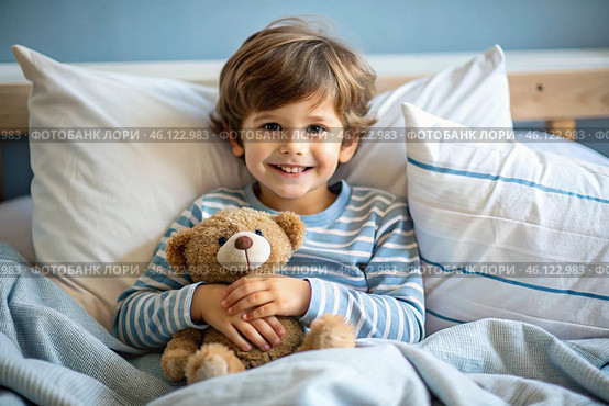 A cute boy hugs a teddy bear, sitting in a cozy bed, a small child hugs a toy and gets ready for bed. A healthy night's sleep. Стоковое AI-изображение, AI-художник Photojuli / Фотобанк Лори