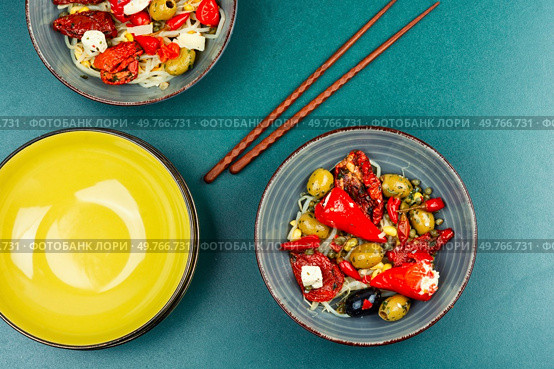 A delicious salad of pickled soybean sprouts, dried tomatoes, olives and peppers. Chinese food.. Vegan Salad of Pickled Vegetables and Soybeans. Стоковое фото, агентство Ingram Publishing / Фотобанк Лори