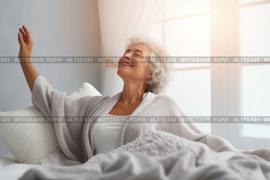 A happy mature woman stretching in a sunlit bedroom to embrace a fresh morning. Стоковое AI-изображение, AI-художник Sergey Grishin / Фотобанк Лори
