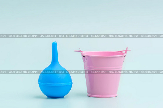 A large enema stands rowed in a small bucket. The concept of severe punishment. Стоковое фото, фотограф Татьяна Степанищева / Фотобанк Лори