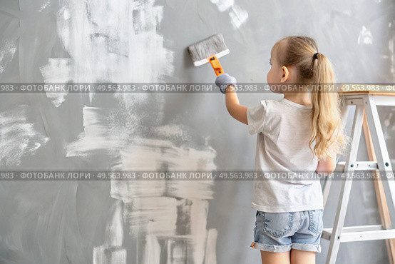 A little girl paints a wall in a new house. Interior decoration of the house, wall painting. Cosmetic repairs. Child labor. Стоковое AI-изображение, AI-художник Photojuli / Фотобанк Лори