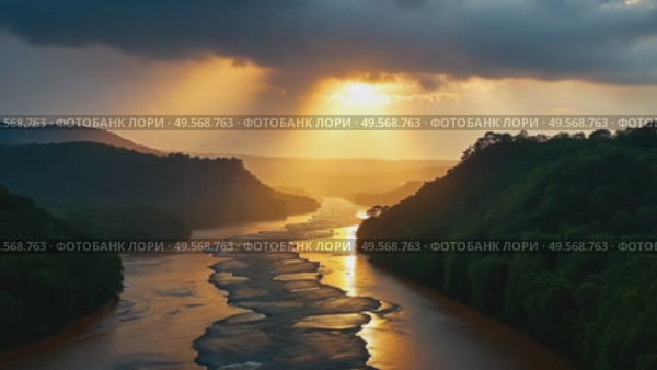 A majestic river flows through green forested hills against a golden sunset landscape with dramatic skies and sunbeams. Стоковое AI-видео, аниматор Анжелика Самсонова / Фотобанк Лори