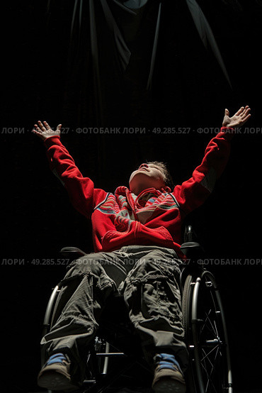 A man in a wheelchair with his arms extended outwards. Стоковое AI-изображение, AI-художник Данила Большаков / Фотобанк Лори