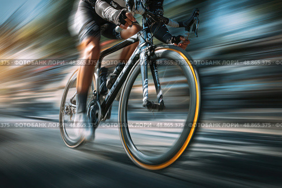 A man is riding a bicycle down a road. Стоковое AI-изображение, AI-художник Ярославский Максим / Фотобанк Лори