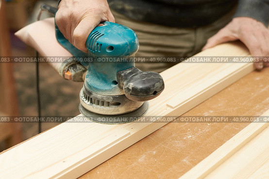A man treats a wooden product with a grinding machine. Стоковое фото, фотограф Стас Пересыпкин / Фотобанк Лори
