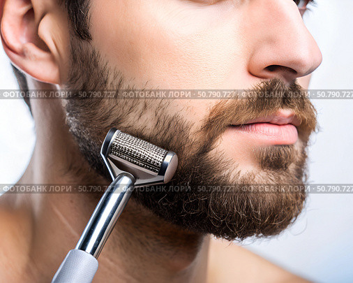 A man using a meso roller on his bearded face, focusing on improving beard growth with detailed attention to facial hair care. Стоковое AI-изображение, AI-художник Ольга Игнашина / Фотобанк Лори