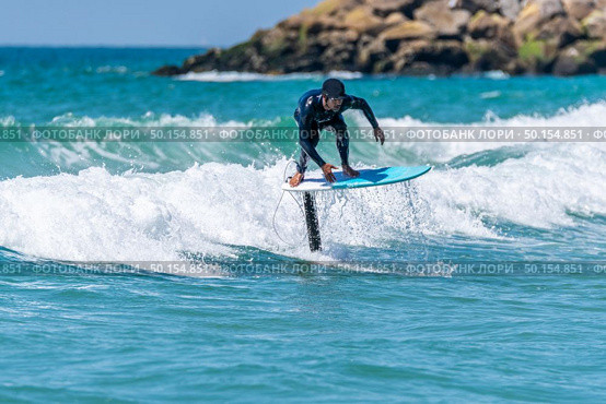 A middle aged man doing some foil surfing or hydrofoil surfing in the sea on a bright sunny day. Стоковое фото, агентство Ingram Publishing / Фотобанк Лори