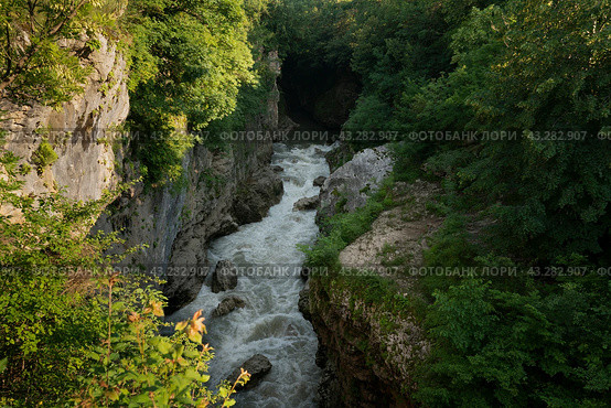 A picturesque natural corridor in a limestone formation laid by the course of the Belaya River - Khadzhokhskaya Gorge (Kamennomost Canyon) on a summer day, Kamennomostsky, Republic of Adygea, Russia. Стоковое фото, фотограф Ula Ulachka / Фотобанк Лори