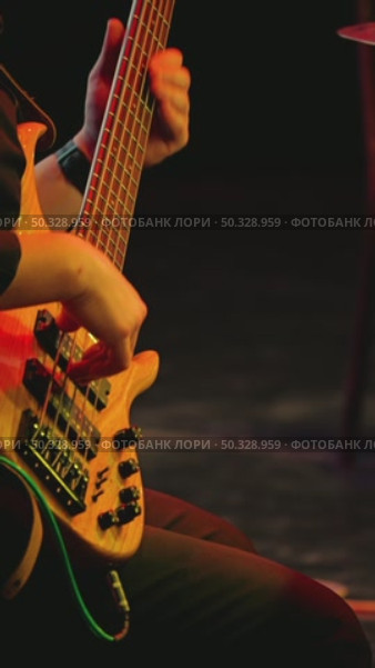 A professional musician plays a five-string bass guitar quickly and skillfully. Concert of jazz or rock band. Стоковое видео, видеограф Воловодов Владимир / Фотобанк Лори