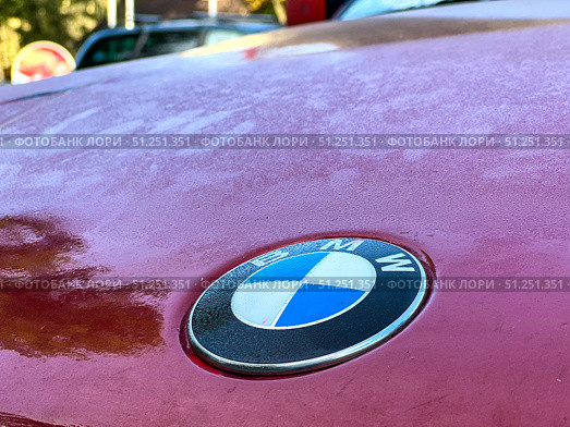A red car with a Bmw emblem on the hood. Russia. Moscow. 05.09.25. Редакционное фото, фотограф Ярославский Максим / Фотобанк Лори