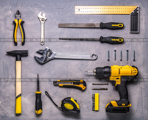 a set of yellow hand tool on a gray background. Стоковое фото, фотограф Енваев Андрей / Фотобанк Лори