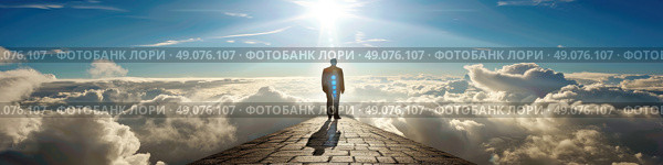 A solitary figure walks along a paved path, with a brilliant sun shining above. The individual is dwarfed by the vast expanse of clouds below. Стоковое AI-изображение, AI-художник Данила Большаков / Фотобанк Лори