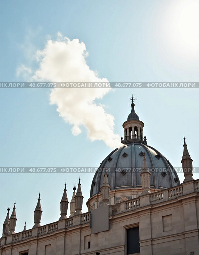 A swirling plume of white smoke escapes from the Sistine Chapel, signaling the election of a new pope. The bright sky enhances the historic moment above Vatican City Generative AI. Стоковое AI-изображение, AI-художник Юлия Петровская / Фотобанк Лори