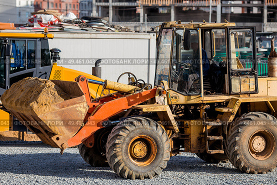 A tractor on a construction site in close-up. Heavy machinery for construction and landscape design. Стоковое фото, фотограф Photojuli / Фотобанк Лори