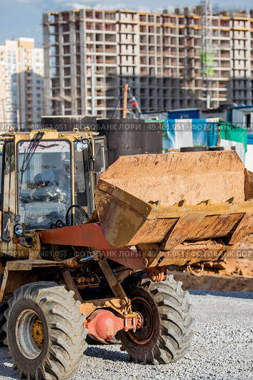 A tractor on a construction site in close-up. Heavy machinery for construction and landscape design. Стоковое фото, фотограф Photojuli / Фотобанк Лори