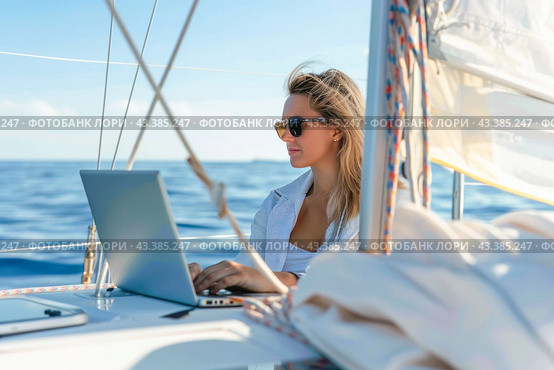 A woman is leisurely using a laptop on a sailboat in the midst of the ocean under the azure sky. Стоковое AI-изображение, AI-художник Юрий Поздников / Фотобанк Лори