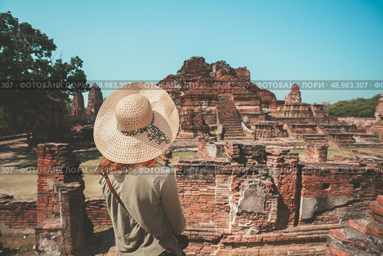 A young woman is exploring the ancient ruins of a buddhist temple city. Стоковое фото, агентство Ingram Publishing / Фотобанк Лори