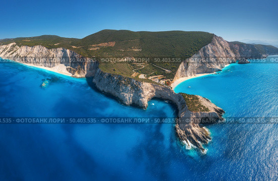 Aerial view of blue sea, mountains, white sandy beach at sunny day in summer. Panorama. Porto Katsiki, Lefkada island, Greece. Beautiful landscape with sea coast, rocks, azure water, sky. Top view. Стоковое фото, агентство Ingram Publishing / Фотобанк Лори