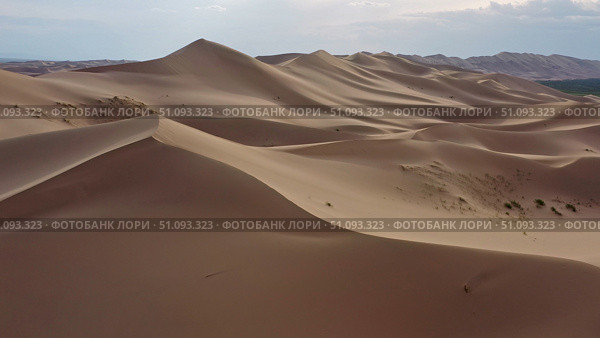 Aerial view of sand dunes in desert at sunset. Стоковое фото, фотограф Михаил Коханчиков / Фотобанк Лори