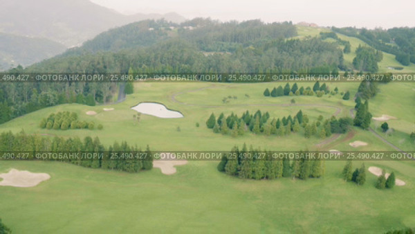 Aerial View of the Golf Course in Mountains. Стоковое видео, видеограф Discovod / Фотобанк Лори