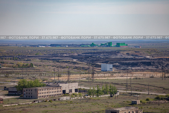 Aerial view on Mechel company mining and processing plant. Quarry and abandoned industrial building on foreground. Стоковое фото, фотограф Alexey Rezvykh / Фотобанк Лори