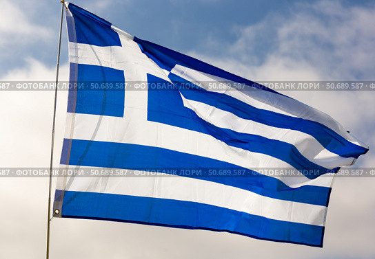 Against background of cloudy sky,white-blue flag of Greece flutters on flagpole. Стоковое фото, фотограф Яков Филимонов / Фотобанк Лори