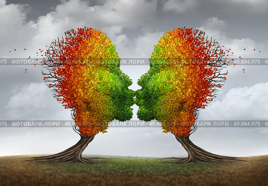 Aging couple relationship symbol and losing sex drive concept or low sexual desire metaphor as two trees shaped as kissing human heads losing leaves as in autumn season. Стоковое фото, агентство Ingram Publishing / Фотобанк Лори