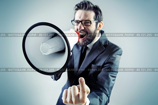 Agressive young businessman yelling over the megaphone. Стоковое фото, агентство Ingram Publishing / Фотобанк Лори