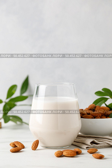 Almond milk in a glass and almond nuts. Стоковое фото, агентство Ingram Publishing / Фотобанк Лори