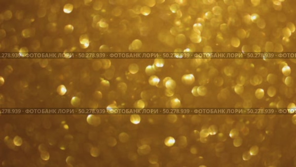An abstract gold background with sparkle lights and bokeh. Useful as Christmas background or greeting card. Gold blurred light. Стоковое видео, видеограф Марина Демидюк / Фотобанк Лори