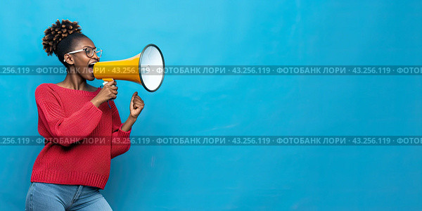 An African woman protests while filming using a loudspeaker on a blue background. Copy space. Стоковое AI-изображение, AI-художник Ярославский Максим / Фотобанк Лори