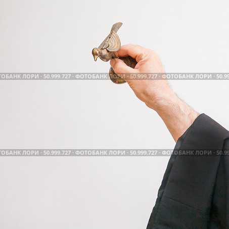 An Armenian priest holds a bird figurine in his hand and performs the rite of baptism over the font. Стоковое фото, фотограф Екатерина Красникова / Фотобанк Лори
