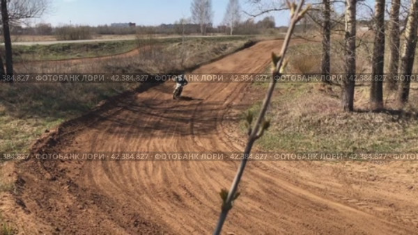 An athlete on a cross-country motorcycle makes a jump at speed. Close-up shooting. Russia. Moscow region. 03.05.2021 (2024 год). Редакционное видео, видеограф Ярославский Максим / Фотобанк Лори