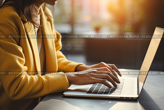 An unidentified young girl in a yellow jacket is typing on a laptop. Generated by AI. Стоковое AI-изображение, AI-художник Ярославский Максим / Фотобанк Лори
